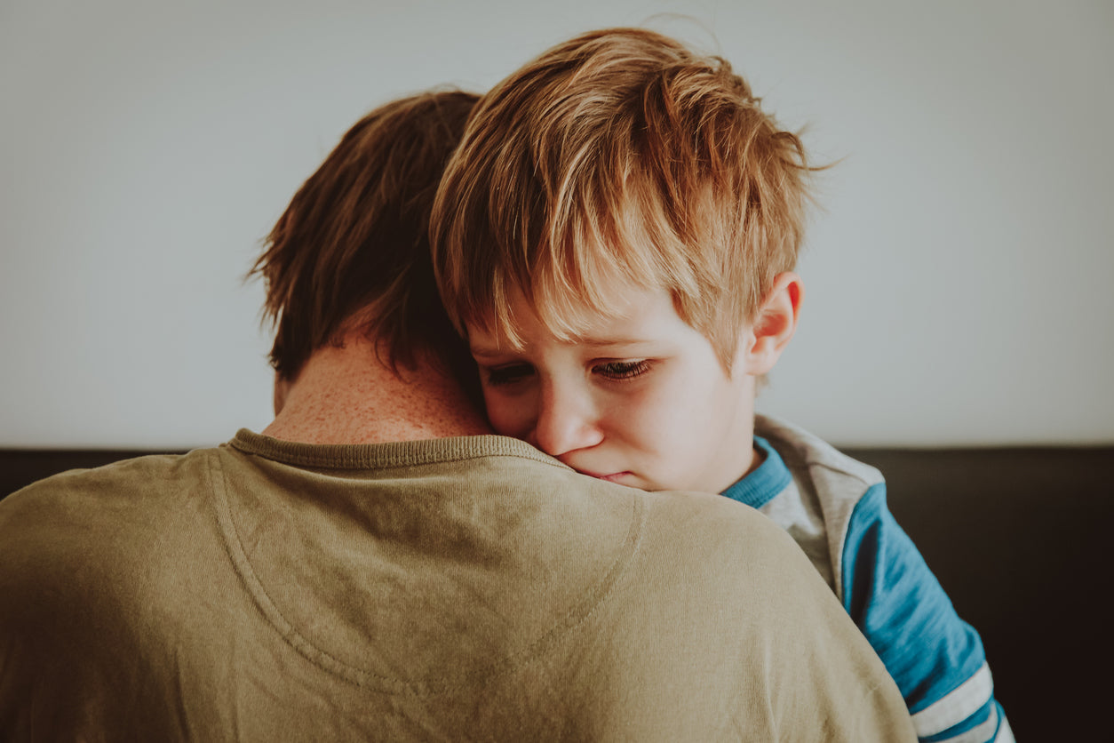A parent comforting a child who is grieving the loss of their family pet.