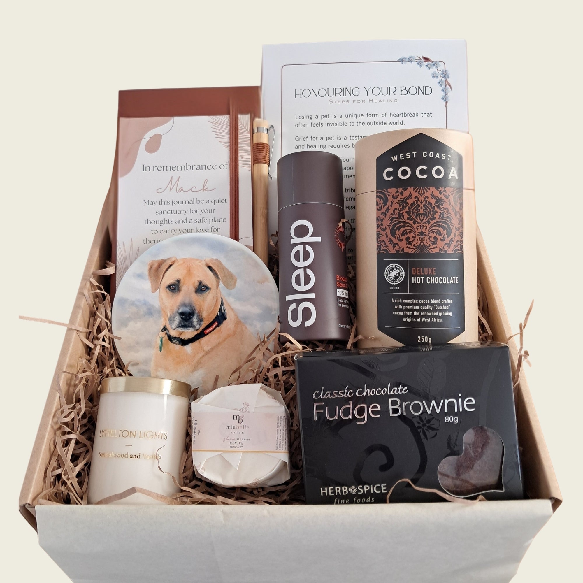 Pet sympathy gift box with personalised coaster, remembrance journal, hot chocolate, brownie, and candle. 