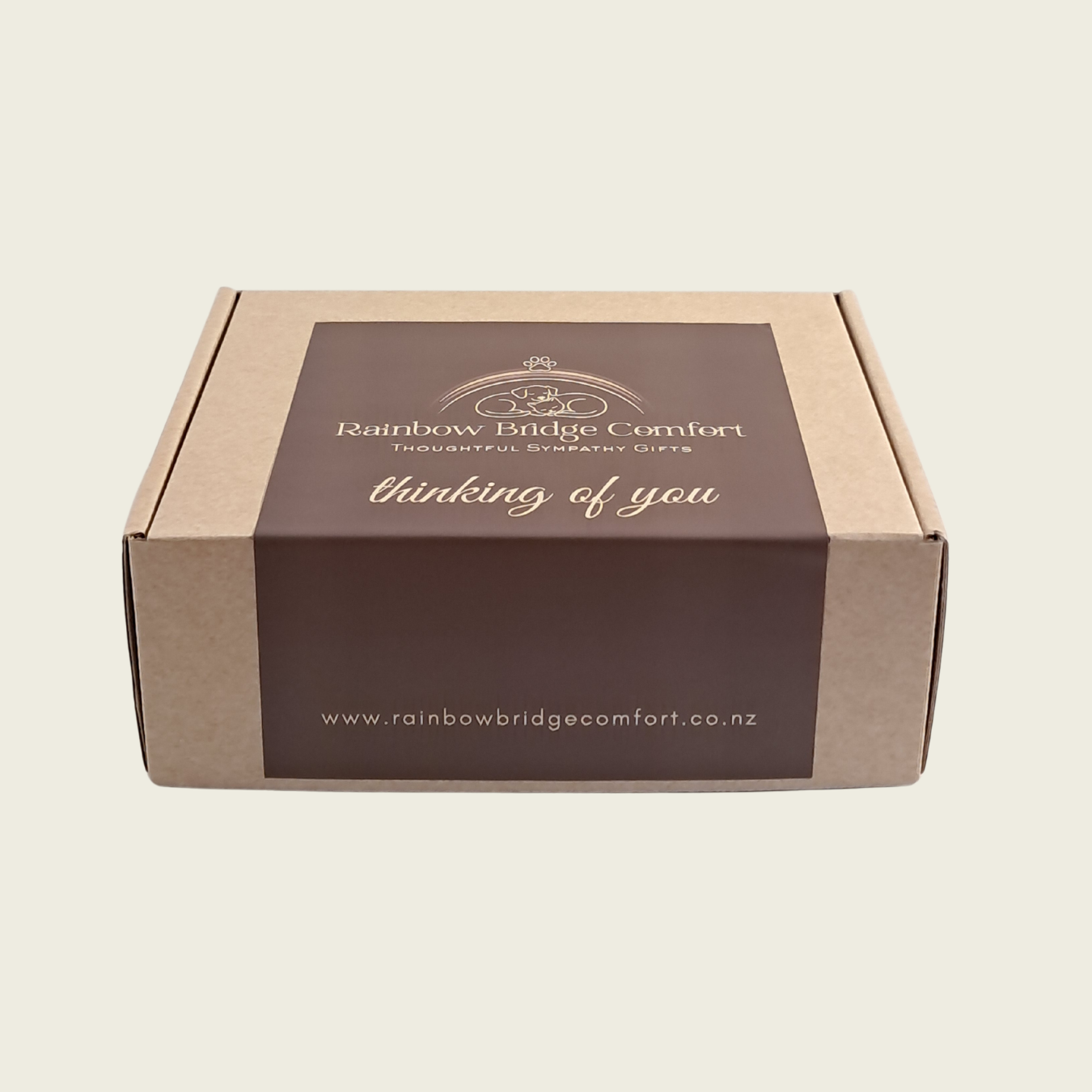 Cardboard box with 'Rainbow Bridge Comfort' branding on a beige background