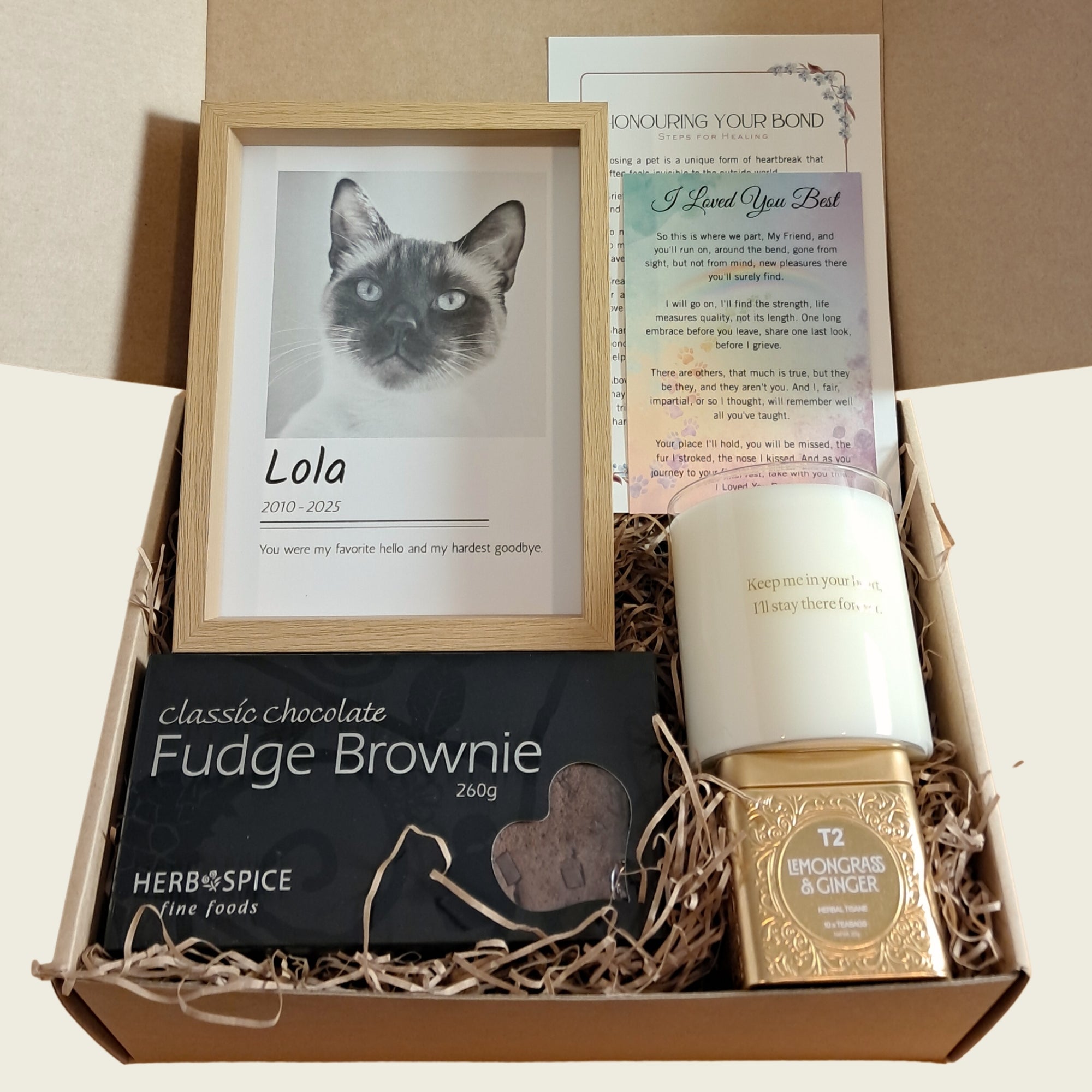 Remembrance Deluxe pet sympathy gift box open showing custom memorial photo frame, soy candle, chocolate brownie, gourmet tea, and sympathy card, New Zealand.

