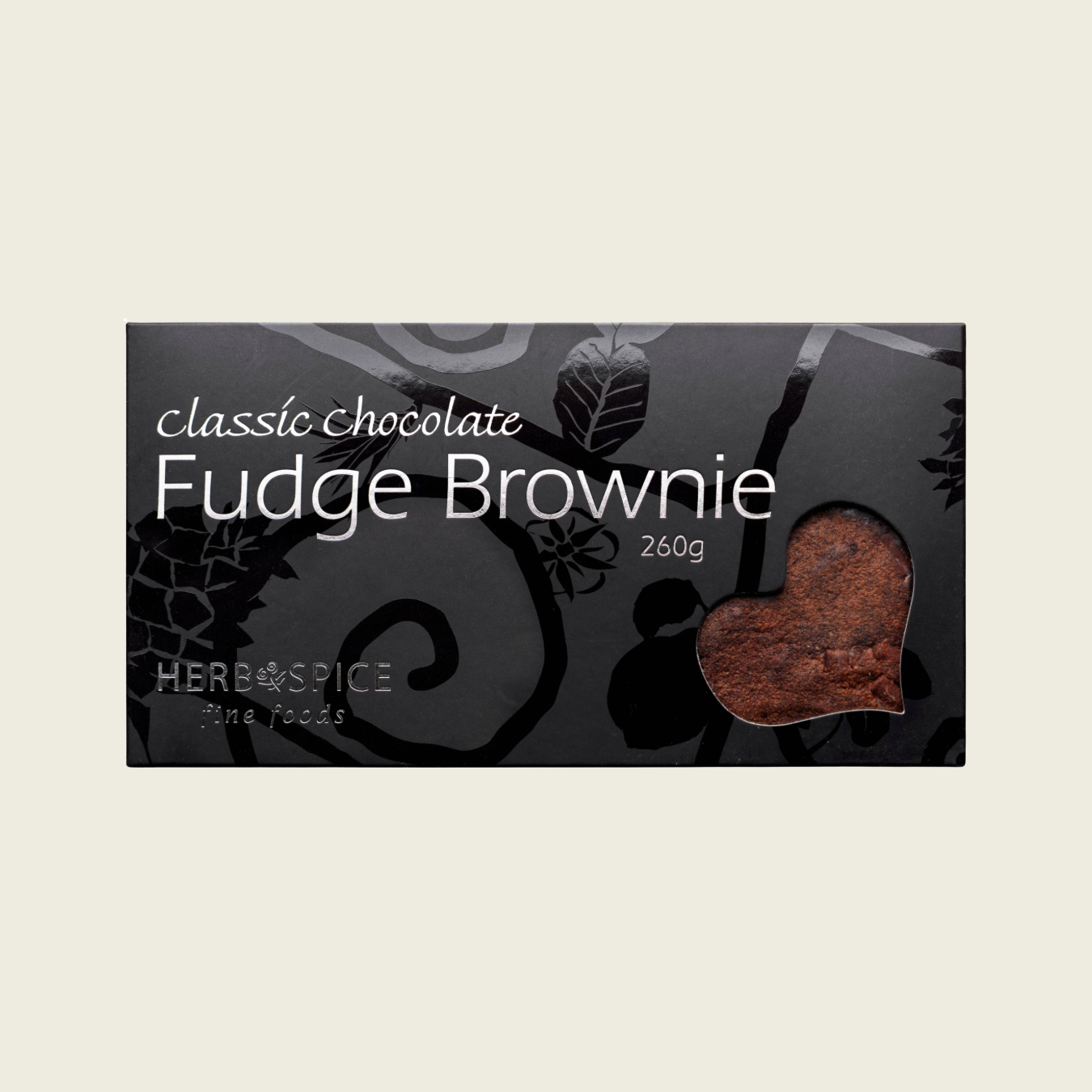 Fudge brownie packaging with a heart-shaped piece of brownie on a dark background