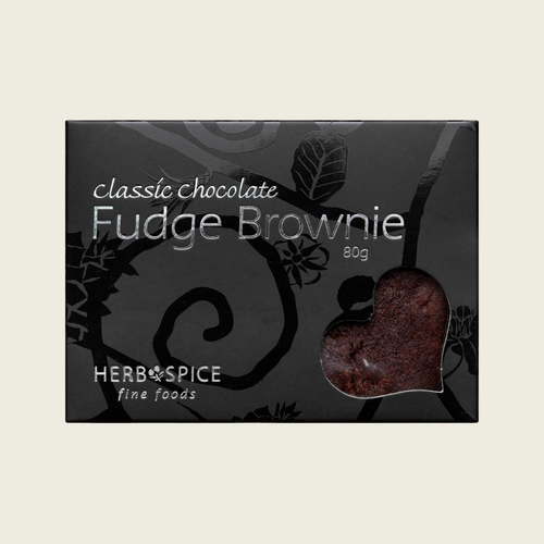 Packaging of classic chocolate fudge brownie by Herb & Spice on a light beige background