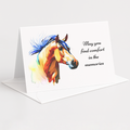 A white standing greeting card with a colorful watercolor illustration of a horse and the printed message 'May you find comfort in the memories,' shown on a clean light gray background with an envelope behind it.