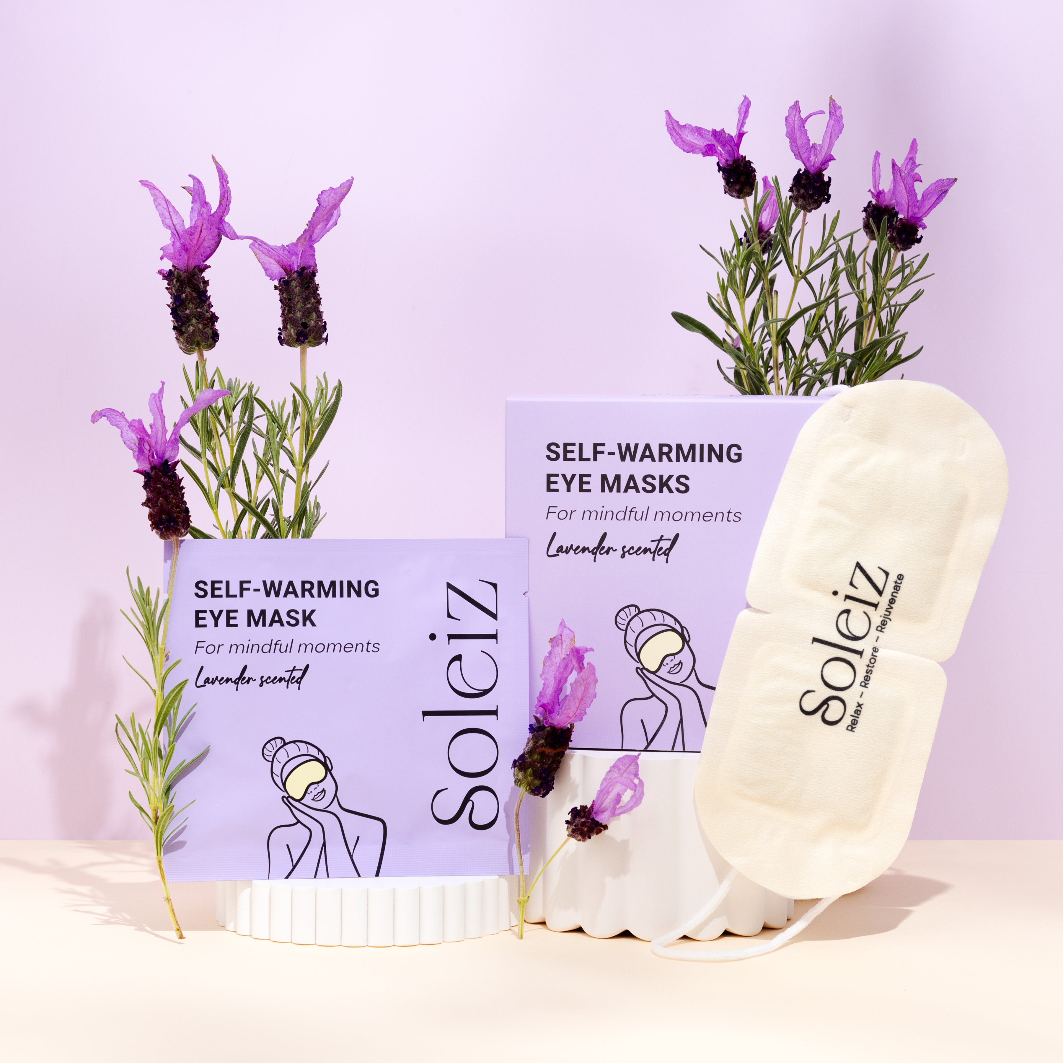 Soleiz self-warming eye masks with lavender scent packaging on a light purple background